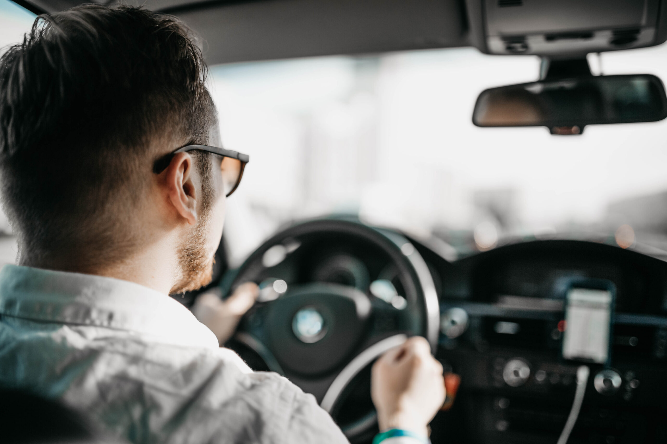 driver businessman rides a business class car through the city in sunglasses. luxury taxi services.